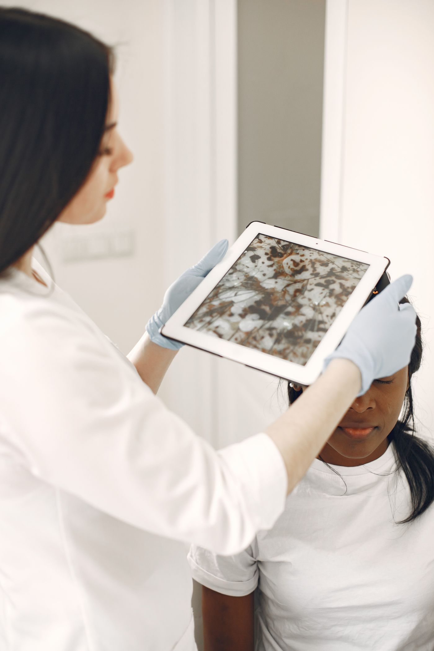 Dermatologist discussing treatment with a patient
